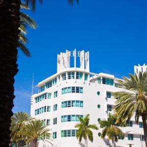 
a large building with a large clock on top at Albion Hotel in Miami Beach
