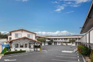 an empty parking lot in front of a hotel at Days Inn by Wyndham Monterey Downtown in Monterey