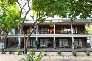 an exterior view of a building with trees at Karancho Beach House in Mactan