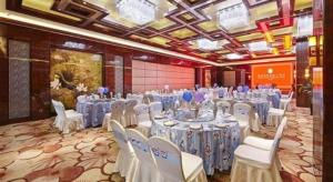 a banquet hall with white tables and chairs in a room at Mingfa International Hotel in Yangzhou