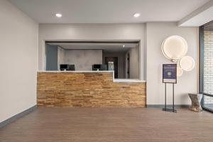 a lobby with a stone wall and a mirror at ECHO Suites Extended Stay by Wyndham Johnson City Medical CR in Johnson City