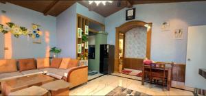 a living room with a couch and a table at Msk Hotel & Restaurant in Jāmb