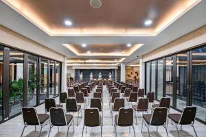 a row of chairs in a room with windows at Lotus Hotel Subang in Subang