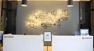 a chandelier hanging on a wall in a room at Echarm Hotel Beihai Railway Station in Dianbailiao