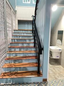 a staircase in a bathroom with a sink at บ้านแม่เกสต์เฮ้าส์ Bann Mae in That Phanom
