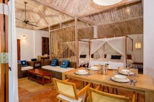 a room with a dining table and a bed at My Dream Boutique Resort in Luang Prabang