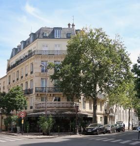 a large building with cars parked in front of it at WS Molitor - Auteuil in Paris