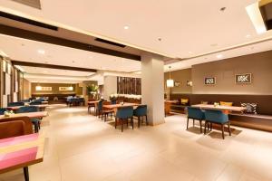 a dining room with tables and chairs in a restaurant at Yitel Collection Shenyang Imperial Palace Zhongjie Metro Station in Shenyang