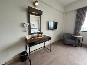 a room with a desk and a mirror and a chair at Swing & Pillows - I-City, Shah Alam in Klang