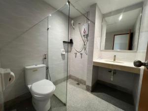 a bathroom with a shower and a toilet and a sink at Swing & Pillows - I-City, Shah Alam in Klang