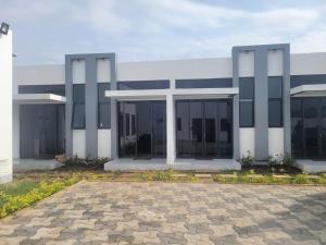 a large building with glass windows and a patio at MARIGOLD APARTMENTS in Salama Park in Lusaka