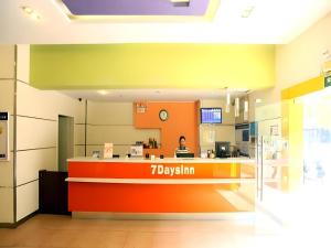 a lobby of a restaurant with a person standing at a counter at 7 Days Inn Nanchang Bayi Square Zhongshan Road Wanshou Palace in Nanchang