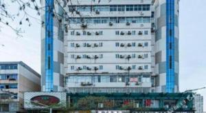 a tall white building with writing on the side of it at 7 Days Inn Nanchang Bayi Square Zhongshan Road Wanshou Palace in Nanchang