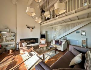 a living room with a couch and a table at Mas La Bellevue in Murs