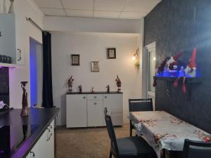 a kitchen with a table and a table and chairs at Garsoniera Luxury central 2 in Craiova