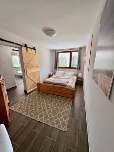 a bedroom with a bed and a large window at Sárffy Vendégház in Szőce +81 photos