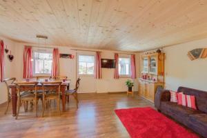 a living room with a table and a couch at Bauernhof Fendrig Neue Wohnung in Haslen
