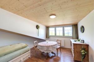 a room with a table and a bed and a table at Bauernhof Fendrig Neue Wohnung in Haslen +25 photos