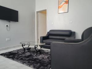 a living room with a couch and a coffee table at MARIGOLD APARTMENTS in Salama Park in Lusaka