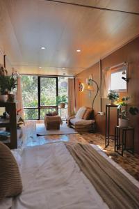 a living room with a bed and a couch at Xing Retreat & Spa Măng Đen in Kon Plong