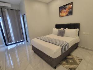 a bedroom with a bed in a room at MARIGOLD APARTMENTS in Salama Park in Lusaka +4 photos