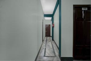 a hallway with a door in a building with a floor at Townhouse Howell Crossway Shillong Formerly Laban Guest House in Shillong