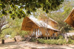 a wooden house with a metal roof at The Seraya Resort Komodo in Labuan Bajo