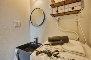 a sink in a hospital room with a mirror at Gamadas BLD in Tokyo +88 photos