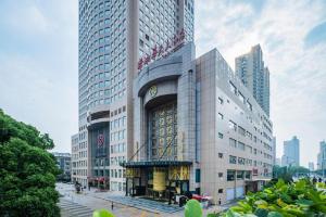 a tall building with a sign on top of it at Changsha Xiaoxiang Huatian Hotel in Changsha