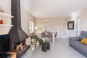 a living room with a couch and a fireplace at Lloret · Villa Gamené piscina y mar in Lloret de Mar