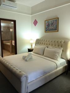 a bedroom with a large bed with a white bedspread at Crown Suits At Times Square in Kuala Lumpur +11 photos