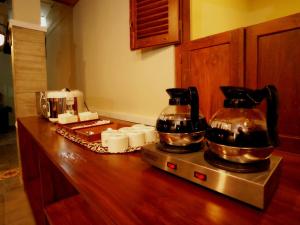 a kitchen counter with two coffee pots on top of it at Yuwono Hotel & Villa Malioboro in Sentool