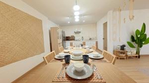 a dining room with a table and a kitchen at Center of old town - 3BR 3BA - Nara Lanna Villa in Chiang Mai
