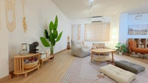 a living room with a couch and a table at Center of old town - 3BR 3BA - Nara Lanna Villa in Chiang Mai