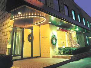 a building with christmas wreaths on the side of it at Kushiro Royal Inn in Irifunechō