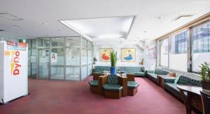 a lobby with couches and a table in a building at Albert Hotel in Dote-nagamachi