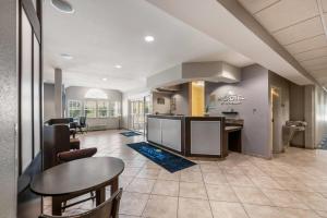 a kitchen and dining room with a table and chairs at Microtel Inn & Suites by Wyndham Pearl River/Slidell in Pearl River