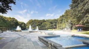 a swimming pool with water fountains in a park at Hotel Livemax BUDGET Chitose in Chitose