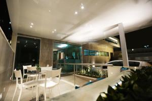 a balcony with a table and chairs on a building at Navegantes Praia Hotel in Recife