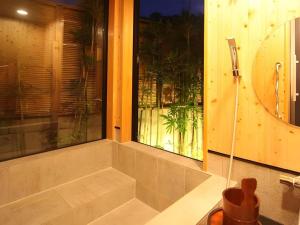 a room with a window with a view of a garden at Suigetsurou Hotel in Tonami +187 photos