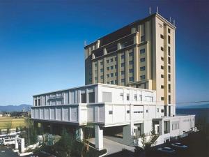 a large white building with a lot of windows at Imazu Sun Bridge Hotel in Imazu