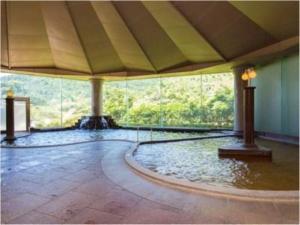 a large room with a pool of water in the middle at Yufuin Onsen Yufuin Nanairo no Kaze in Yufuin +102 photos