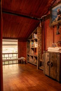 a living room with wooden walls and a wooden floor at SIM Farmstay in Ha Giang