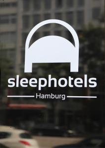 a window with a sign that readssleepblocks hamburger at Sleephotels in Hamburg