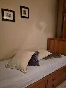 a bed with two pillows on it in a bedroom at Elegantia Domina apartment in the center in Fiumicino