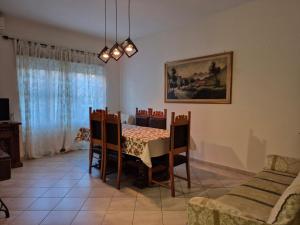 a dining room with a table and chairs at Elegantia Domina apartment in the center in Fiumicino