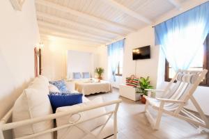 a living room with a white couch and a bed at The Old Ship in Costarainera