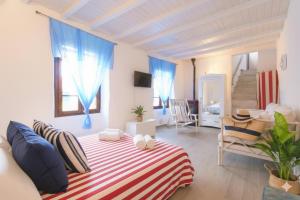 a bedroom with a bed with a red and white striped blanket at The Old Ship in Costarainera +9 photos