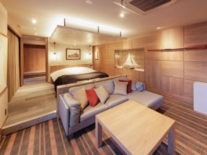 a living room with a couch and a bed at Y-HOTEL - Vacation STAY 22285v in Hiroshima