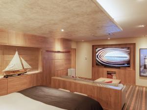 a room with a bed and a boat on the wall at Y-HOTEL - Vacation STAY 22285v in Hiroshima